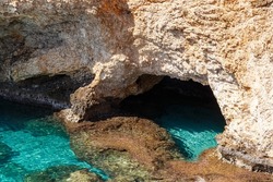 Big Sea Cave. Seascape. Travel concept. Seascape on the background of the wild rocky coast. Wild beach, azure water and rocks. Mediterranean sea, Cyprus. Postcard view