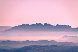 Relief of different mountains covered by fog at dawn. Spain, Catalonia, Barcelona, Montserrat.