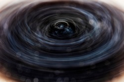 Abstract blurred background with powerful rotating turbulent vortex. A dark colored slide cover backdrop on the theme of movement and scientific development.