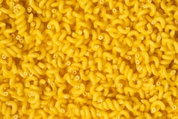 texture of raw Cavatappi Cellentani noodles pasta italian food macro on background