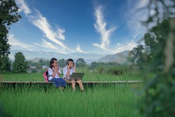 Elementary school children Asians living in rural areas and rural schools of Thailand Primary school children are studying online using their laptop to view materials.