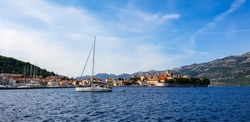 The beautiful city Korcula in Croatia with its historical old town surrounded by the islands of the Adriatic Sea and the breathtaking mountains close to Dubrovnik on a summer day