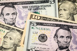 Closeup of ten and five dollar bills. Concept of 15 dollar federal minimum wage increase.