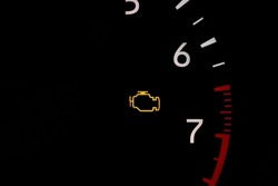 Car check engine warning light on dashboard. Vehicle maintenance, repair and service concept.