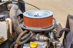 Air filter on lawn mower tractor. Small engine repair, maintenance and tune up concept