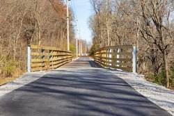 Multipurpose or multiuse bike trail in fall. Rail trail, outdoor recreation and bike path safety concept.