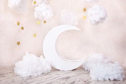 Artificial decorations with a moon and stars. Vintage decorations. Stylish vintage children's room with a wooden moon and textile clouds. vintage children's room with a moon.  Scandinavian style room 