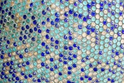 Mosaic background of round glass blue turquoise balls in wall. Colored mosaic square for background texture. Penny round mosaic tiles. Round circle tile. Glass abstract round multicolor mosaic pattern