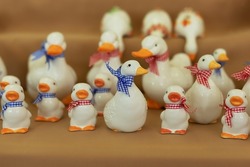 Figurine colorful birds. Ceramic figurine of ducks. Close-up of white statuette of ducks. Porcelain duck. Ceramic figurine of wild bird. Goose, duck, drake