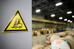 Yellow sign in a warehouse, production - forklift works