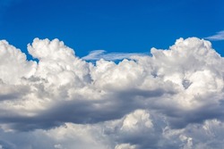 Beautiful fluffy white clouds in dramatic cloudscapes. Blue sky with contrasting puffy clouds. Monsoon clouds in the sky over the Sonoran Desert in Tucson, Arizona, USA.