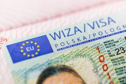 Fragment of a Polish visa in a passport close-up.