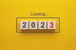 2023 new year loading. Wooden cubes with 2023 on a yellow background. 3d rendering.