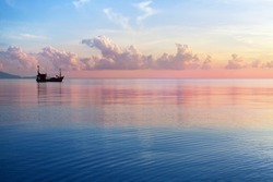 Morning sunrise pink sky, blue sea, white clouds, ship silhouette, scenery landscape, soft color sunset on ocean coast, beautiful seascape, boat and sun reflection on water, Thailand, Koh Samui island
