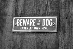 A warning sign which says beware of the dog 