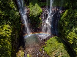 Aerial drone view of the Sekumpul waterfall on Bali. The reflection of rainbow in the flow of water.