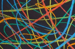 multicolored scribbles  on black paper  background