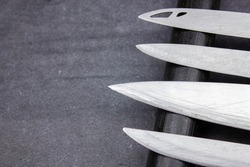 The Blades of knives concept. Sharp steel blades of knives on a dark background. Sharp knives collection.