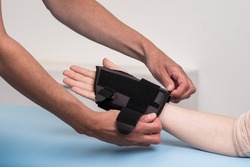 Carpal orthosis or stabilizer is a medical device used to immobilize and support wrist and thumb for treatment of muscle strain and tendinitis. Medical equipment concept.