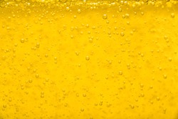 Gold  liquid bubble background with bubbles. Beer or vegetable oil background