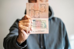 Russian foreign passport in the hands of a man. Prohibition of Schengen visas for Russian tourists to travel to the European Union during the war in Ukraine