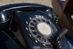 Old black dial telephone device. Call on communication concept 
