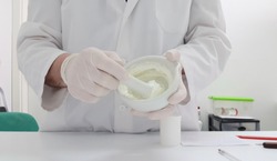 A pharmacist making a cream in the pharmacy laboratory