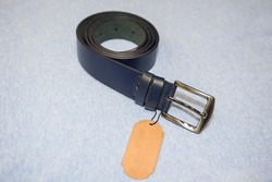 Blue men's leather belt on a textile background with place for text.