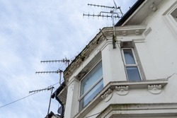 Victorian property with bay window and numerous TV aerials on the roof