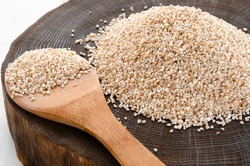 Raw dried broken barley cereal grain texture background macro closeup. Barley groats, coarse barley semolina. Concept of healthy eating protein diet and vegetarianism.