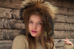 A portrait of beautiful young woman wearing a furry hat