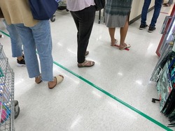 People queuing to pay for goods in a supermarket