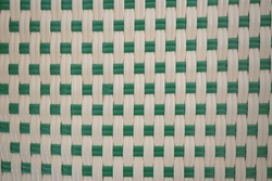Green-white plastic weave texture pattern. It is a popular pattern for mats, baskets, or rattan furniture. Weave pattern handmade for background