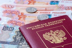Russian Federation passport and Russian banknotes (rubles). Concepts of travel, economic sanctions, money transfers and inflation for citizens of Russia