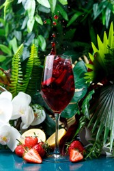 cherry cocktail against the tropics splashed vertical shot decorated with strawberries cocktail menu on a tropical background cocktail menu