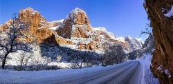 Snowy road in a mountain canyon in winter. Canyon road in snow. Snowy canyon road panorama. Canyon in winter snow