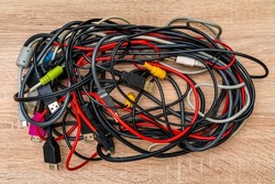 Bundle of various cables with various connectors suitable for different ports. Concept of great number of pc peripherals, equipments and connected devices