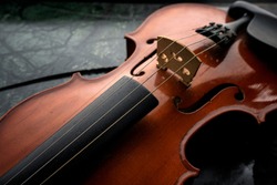 Violin ,Violin on the table dark background ,Violin waist detail on rustic dark background