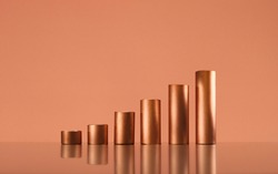 Copper tubes forming a growing bar graph, copy space. Trading and commodity supercycle concept, copy space.