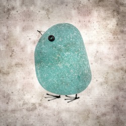 stylish textured old paper background with sea glass pebble penguin