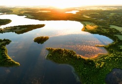 Lake in morning sunrise. Rural landscape. Lake Countryside at dawn in fog, drone view. Lake in Foggy dawn. Freshwater ecosystems. Drink water safe. Global drought crisis. Aerial panoramic landscape.