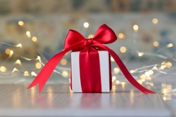 
Close up of Christmas gift packages with satin bows and with Christmas lights and colorful fabrics and red striped white candy canes