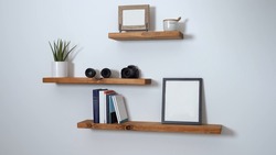 minimalist floating shelf made of wood with books and a picture on it