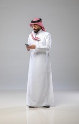 A saudi character holding the phone on withe background