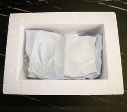 View of the inside of package received by mail with medication that needs refrigeration packed with gel refrigerant in a Styrofoam cooler.