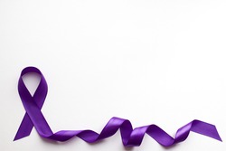 Purple ribbon on white background with place for text in honor of the day of patients with epilepsy on March 26