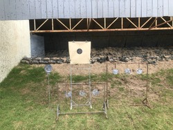 Target practice at outdoor shooting range. paper target and steel plate target