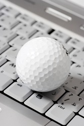 golf ball on a laptop, online gaming concept