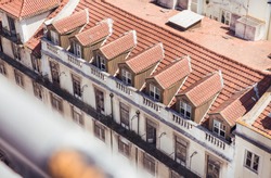 Skyline view of classic building with windows and orange roof in the city of Lisbon, Portugal