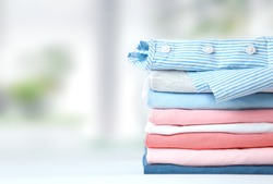 Multicolored stack of clothes,colorful coton loundry folded empty space background.Laundry.